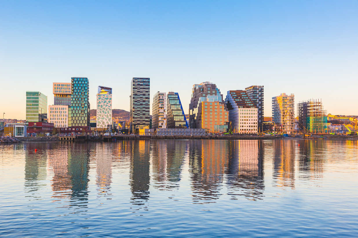 Modern buildings in Oslo, Norway, with their reflection into the water. These are some of the new buildings in the neighbourhood of Bjorvika. Concepts of travel and architecture.