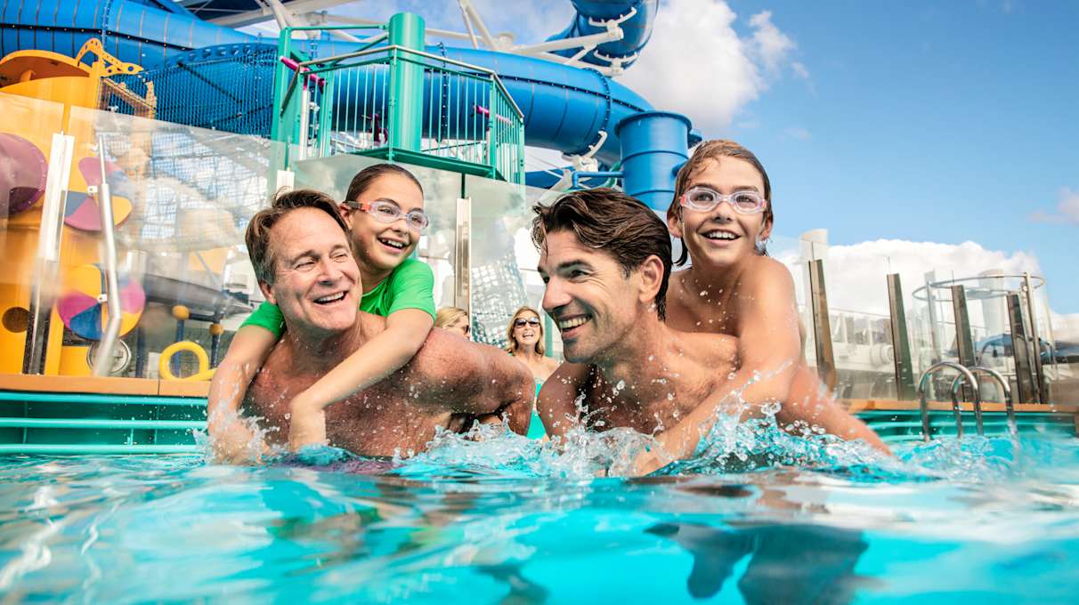 Family in a pool onboard Norwegian Encore